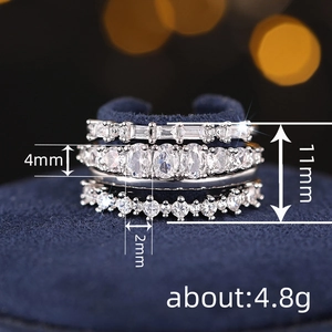 Luxurious four-piece silver ring set with sparkling zircon stones on blue velvet stand