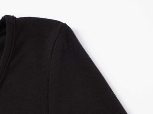 Detailed close-up of U-neck ribbed neckline and shoulder stitching on black cotton bodysuit