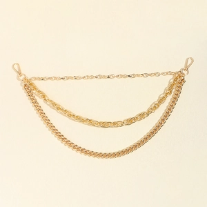 Close-up of triple-layered gold metal waist chains with polished lobster clasps for pants