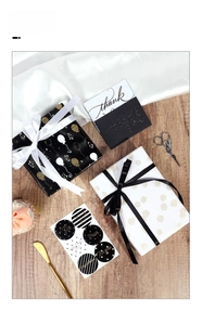 Detail of luxury gold foil balloon wrapping paper set with ribbons and thank you cards