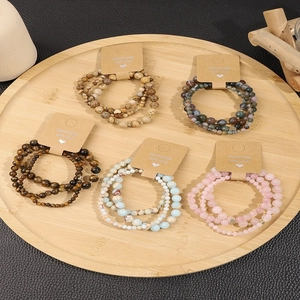 Close-up of handmade natural stone bead bracelet sets on vintage kraft cards