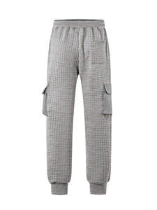 Detailed macro view of gray waffle-textured cargo pants with drawstring and side pocket