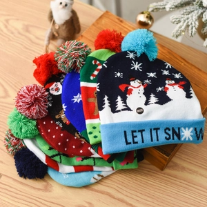 Knitted Christmas LED hats with snowmen and Let It Snow text on festive background
