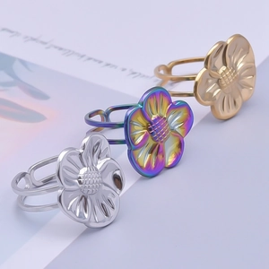 Detailed view of 3-piece adjustable floral rings in silver, gold, and rainbow finishes