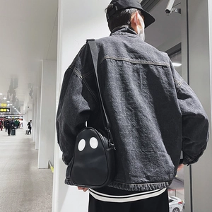 Close-up of cute ghost shaped crossbody bag in black PU leather with contrast stitching