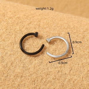 Detail view of 0.9cm black and silver stainless steel U-shaped nose rings weighing 1.2g