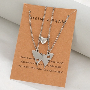 Matching stainless steel butterfly pendant necklaces with heart charm on a wish card