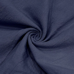 Detail shot of navy blue linen fabric showing the high-quality woven texture and drape