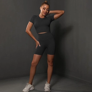 Detailed texture of seamless high-elastic gray crop top and peach butt fitness shorts