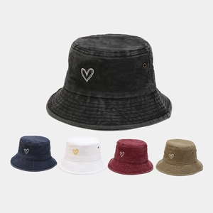 Detailed view of washed cotton bucket hats featuring heart embroidery in five vintage colors