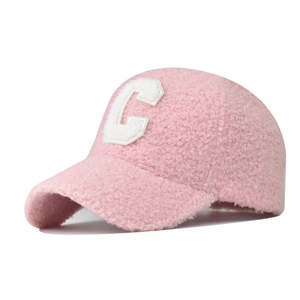 Close-up of pink faux shearling baseball cap with embroidered letter C patch detail