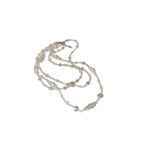 Layered iridescent glass bead necklace with shimmering rainbow finish and metal clasp