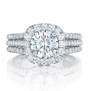 Elegant halo style ring featuring round cut central zircon and triple row diamond band