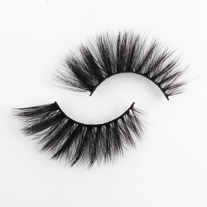 Macro shot of 3D faux mink eyelashes with thick, fluffy, and curly black fibers
