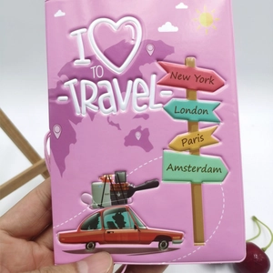 Detail of pink passport cover featuring 3D embossed travel slogans and city signs