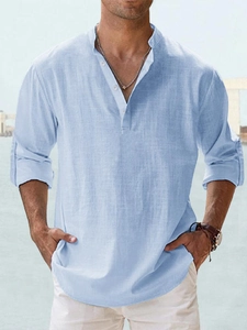 Detail view of light blue linen shirt fabric texture and casual henley neck for men