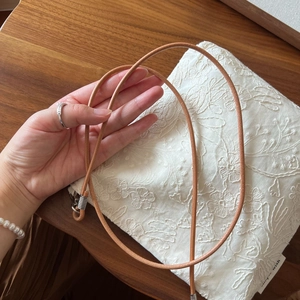 Detail view of cotton linen crossbody phone bag with 3D floral embroidery and leather strap