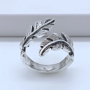 Detailed close-up of a vintage silver feather ring with an adjustable open design