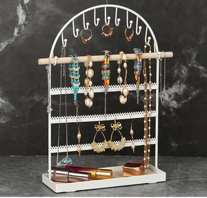 Close-up of the arched 5-tier jewelry stand with white metal frame and wood base