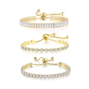 Three gold tennis bracelets with rectangle, oval, and round cubic zirconia and slide clasp