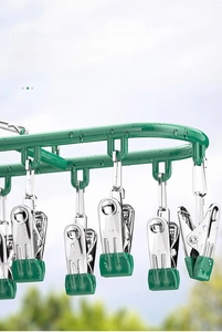 Close-up of waterproof stainless steel laundry rack with green clips and water droplets