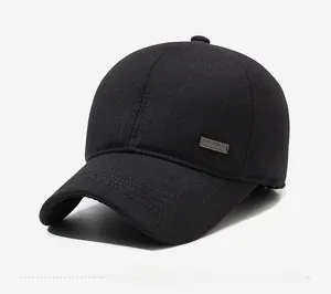 Close-up of black winter baseball cap with thick twill fabric and side metal plaque detail