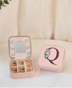 Pink PU leather jewelry box with floral letter Q, built-in mirror, and zipper closure