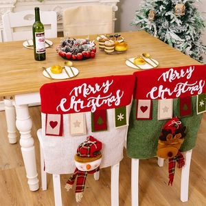 Detail of red and green Christmas chair covers with 3D snowman and reindeer dolls