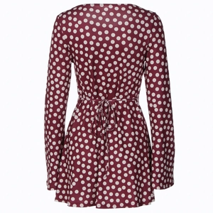 Detailed back view of burgundy polka dot dress featuring lace-up waist design