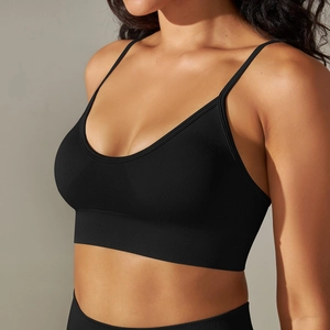 Detail of black seamless yoga bra featuring thin straps and ribbed support band