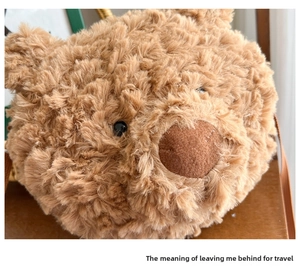 Close-up of a cute brown plush bear head bag with soft faux fur and adjustable strap