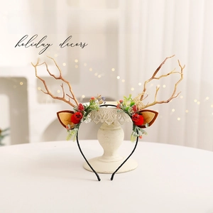 Creative Christmas reindeer antler headband with festive red berries and bells decoration