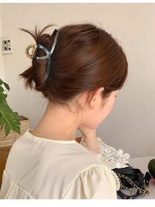 Dark green large shark hair claw clip in a minimalist style for secure bun styling