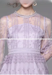 Close-up of purple lace embroidery and woven waist detail on a sheer mesh dress