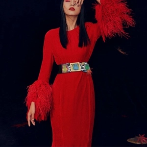 Elastic waist belt featuring green snake pattern and a gold square buckle on a model