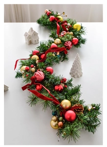 Detailed view of 135cm Christmas garland with red gold baubles, pine cones and ribbons