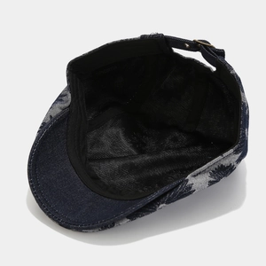 Navy blue cotton daisy print newsboy cap with adjustable buckle and vintage style