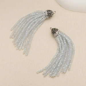 Macro detail of light blue crystal bead tassels with rhinestone-encrusted metal caps