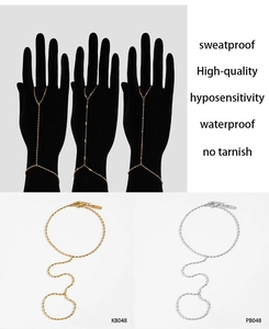 Detail of PVD gold and silver slave bracelets showing finger rings and chain connection