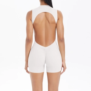 Detail of white backless yoga bodysuit featuring ruched lifting seam and open back design
