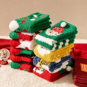 Thick coral fleece Christmas socks featuring festive patterns on a cozy winter background