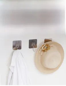 Macro view of strong adhesive wall hooks for organizing clothes and hats behind doors