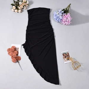 Detail of black strapless dress featuring layered ruffles and ruched elastic fabric