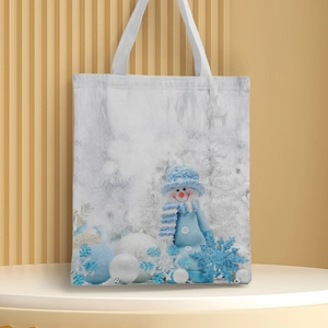 Detail of Christmas snowman and snowflake prints on a high-quality white canvas tote bag