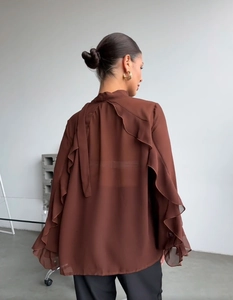 Detail of ruffle pleated back and bell sleeves on a dark brown chiffon blouse top