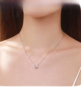 Macro view of dainty S925 silver necklace featuring a colorful iridescent zircon pendant