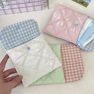 Quilted menstrual pad storage bags in pastel colors with checkered lining and snap closure