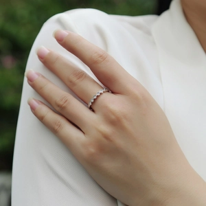 Elegant 925 sterling silver wave ring with zircon inlay on model hand in white setting