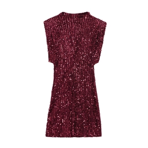 Close-up of sparkling wine red sequins on a sleeveless mini dress showing texture