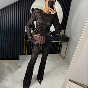 Mirror selfie showing details of a black lace long sleeve jumpsuit with flared legs